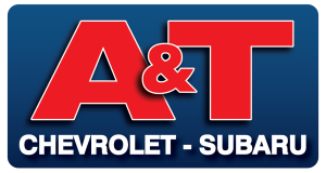 Logo with large red letters "A & T" above white text reading "Chevrolet - Subaru" on a blue gradient background.
