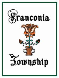 A logo with ornate black text reading "Franconia Township" and an illustration of an orange and yellow flower in a brown pot between the words.