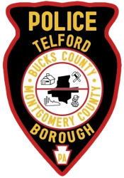 Black and gold police badge with “Police Telford Borough” and “Bucks County Montgomery County,” featuring a county map and icons of a train, factory, handshake, and tools in the center.