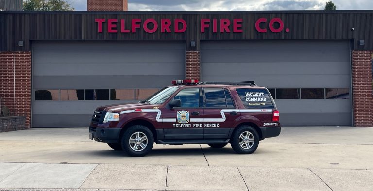 A maroon Telford Fire Rescue SUV labeled "Incident Command" is parked in front of the Telford Fire Co. building with three closed garage doors.